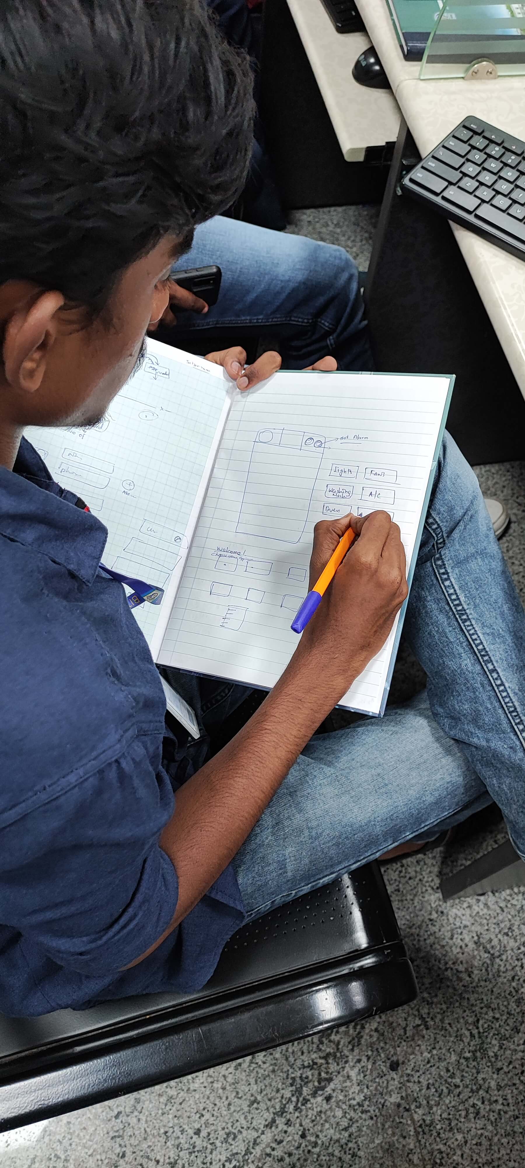 Sketching wireframes by hand in a notebook